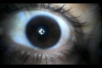 The video still shows a close-up of an eye that is staring directly into the camera. The pupil reflects light source.