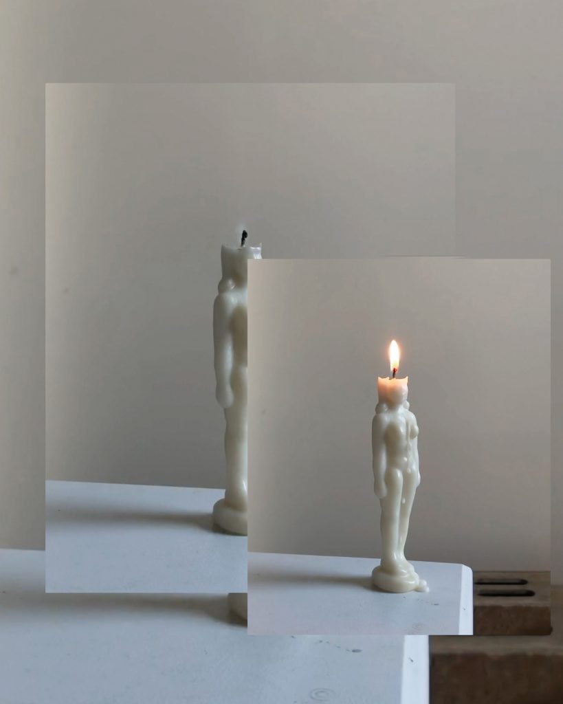 An image of a human-shaped candle with breasts on a table, superimposed over two images of the same scene. The background image is mostly obscured, while the middle image shows the candle put out. The top and smallest image shows the candle lit and dripping wax.