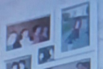 This is a photo that is out of focus. It captures a small section of a wall where there are what appears to be family photos hanging.