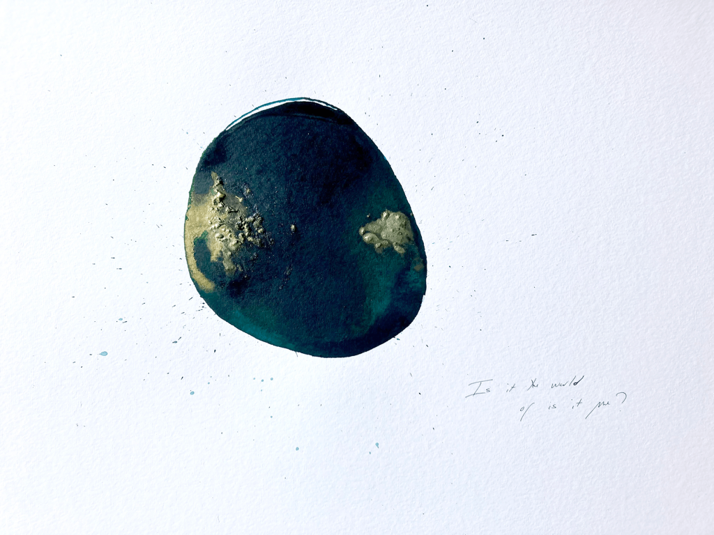 A small dark blue water blot with shimmering highlights of gold.