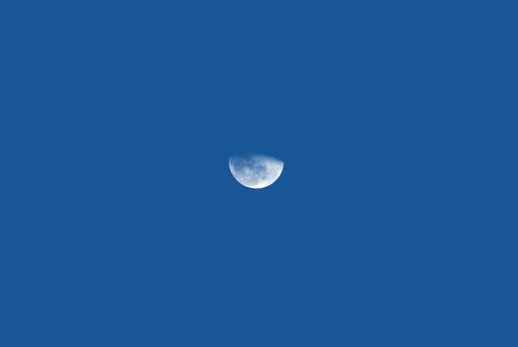 A photo of the moon against a blue background.