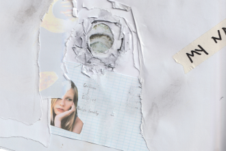 A multilayered collage that appears like a school book where somebody stuck a finger through its pages and left a deep hole. Contains an image of Kirsten Dunst in the movie The Virgin Suicides